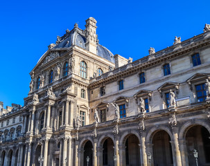 Fototapeta na wymiar Architectural details of the facade of the Louvre palace in Paris, France. April 2019