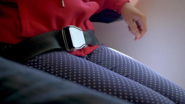 close-up plane passenger fasten seatbelt