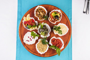  Mediterranean cuisine, European dish. set of appetizers served in mussel shells, dolma- Uzbek dish, ground beef and rice, wrapped in grape leaves, pickled mushrooms, plum sauce, tartar sauce, barbecu