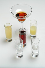 Different colorful alcoholic drinks on gray background