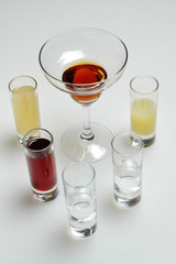 Different colorful alcoholic drinks on gray background
