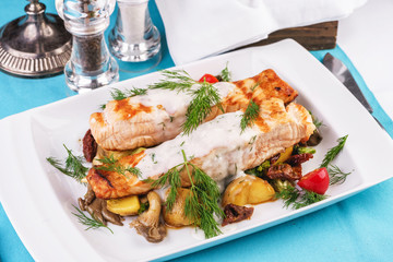 Seafood, Mediterranean cuisine. Grilled salmon fish steak with grilled vegetables and oyster mushrooms. Caucasian kitchen