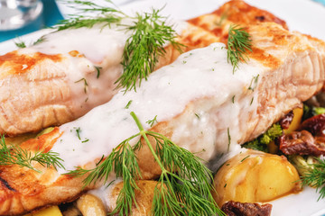 Seafood, Mediterranean cuisine. Grilled salmon fish steak with grilled vegetables and oyster mushrooms. Caucasian kitchen