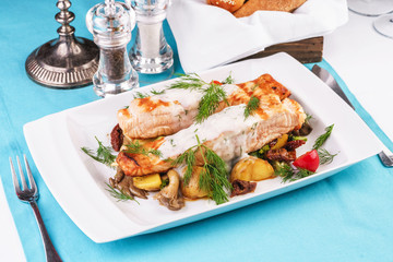 Seafood, Mediterranean cuisine. Grilled salmon fish steak with grilled vegetables and oyster mushrooms. Caucasian kitchen