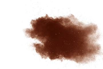 Freeze motion of brown powder exploding. Abstract design of color powder cloud against white...