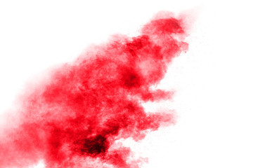 Abstract red dust splattered on white background. Red powder explosion.Freeze motion of red particles splashing.
