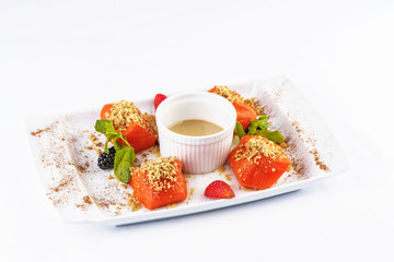 Turkish dessert recipe. Pumpkin baked in honey with nuts, served with scaram sauce and berries - strawberries, blueberries