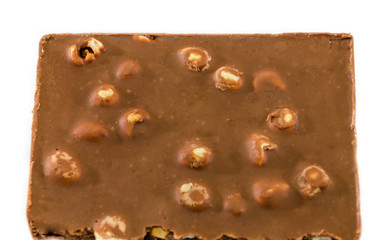 milk chocolate with nuts on a white background, closeup