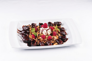 Berry-chocolate cake with ice cream, chocolate sauce and dates