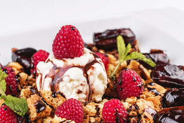 Berry-chocolate cake with ice cream, chocolate sauce and dates