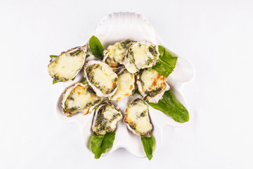 Mediterranean dish, European cuisine. baked mussels under creamy cheese crust with greens