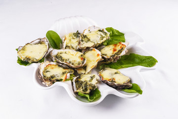 Mediterranean dish, European cuisine. baked mussels under creamy cheese crust with greens