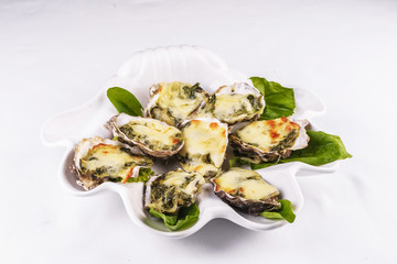 Mediterranean dish, European cuisine. baked mussels under creamy cheese crust with greens
