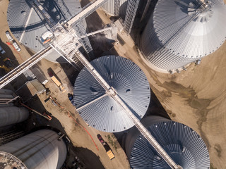 Aerial high angle view of industrial grain elevators and dryers in South Dakota.