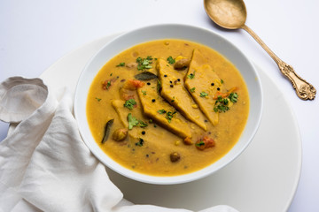 Dal Dhokli, Varan Phal or Chakolya is a gujarati, Rajasthani and maharashtrian dish made using diamond shape wheat flour cakes boiled in a dal. It's an easy one pot meal. served in a bowl.