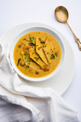Dal Dhokli, Varan Phal or Chakolya is a gujarati, Rajasthani and maharashtrian dish made using diamond shape wheat flour cakes boiled in a dal. It's an easy one pot meal. served in a bowl.