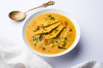 Dal Dhokli, Varan Phal or Chakolya is a gujarati, Rajasthani and maharashtrian dish made using diamond shape wheat flour cakes boiled in a dal. It's an easy one pot meal. served in a bowl.