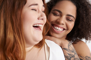 Happy woman is laughing with female friend
