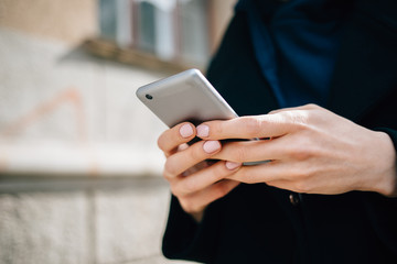 Young woman using smart phone standing outside