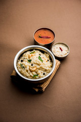 Ven pongal recipe is a popular South Indian food prepared with rice & moong dal and served with sambar and coconut chutney, selective focus