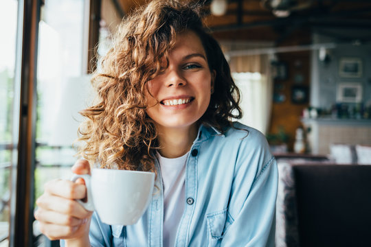 Happy young woman with curly hair