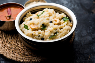 Ven pongal recipe is a popular South Indian food prepared with rice & moong dal and served with sambar and coconut chutney, selective focus