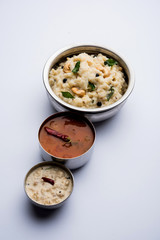 Ven pongal recipe is a popular South Indian food prepared with rice & moong dal and served with sambar and coconut chutney, selective focus