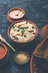 Ven pongal recipe is a popular South Indian food prepared with rice & moong dal and served with sambar and coconut chutney, selective focus