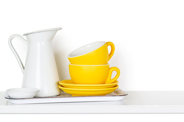 Kitchen dishes on a shelf  isolated on white background