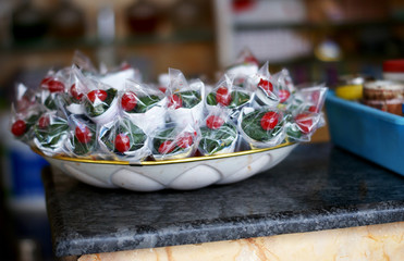 Closeup of Indian sweet paan betel leaf with ingredients prepared and kept in Display of Indian street food vendor shop