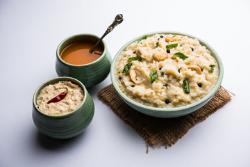 Ven pongal recipe is a popular South Indian food prepared with rice & moong dal and served with sambar and coconut chutney, selective focus