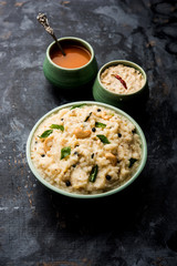 Ven pongal recipe is a popular South Indian food prepared with rice & moong dal and served with sambar and coconut chutney, selective focus