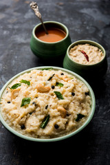 Ven pongal recipe is a popular South Indian food prepared with rice & moong dal and served with sambar and coconut chutney, selective focus
