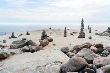 Stacked Rocks balancing, stacking with precision. Stone tower on the shore. Copy space.