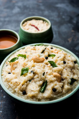 Ven pongal recipe is a popular South Indian food prepared with rice & moong dal and served with sambar and coconut chutney, selective focus