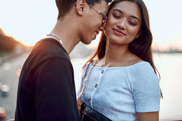 Beloved asian couple enjoying date on sunset