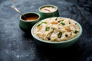 Ven pongal recipe is a popular South Indian food prepared with rice & moong dal and served with sambar and coconut chutney, selective focus