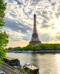 Fototapeta na wymiar The Eiffel Tower across the Seine River in Paris, France on a sunny day with beautiful clouds.
