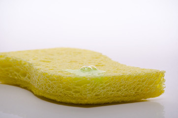 yellow sponge for washing dishes with a drop of detergent, soap bubble, isolated on white background