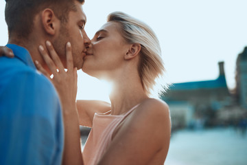 Loving couple kissing in the street with closed eyes