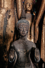 Antique old Buddha statue at Wat Xiang Thong. Luang Prabang, Laos