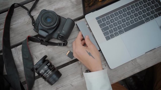 Freelance digital nomad use card adapter on laptop