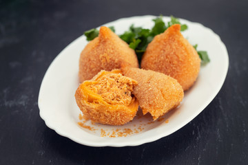 coxinha de frango, typical brazilian chicken croquette on white dish