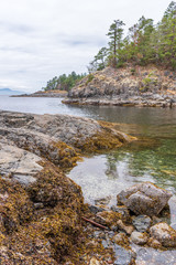 View over Inlet, ocean and island with rocks and mountains in beautiful British Columbia. Canada.