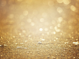 gold abstract blurred background of sandy sunset beach.