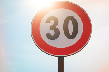 number 30 traffic limit sign in the sunlight