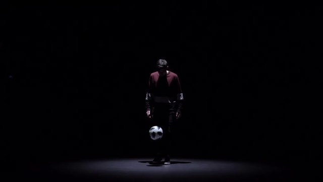 Football freestyle. Football freestyle at dark in studio. Slow motion
