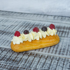 eclairs with vanilla cream cheese decorated with fresh berries