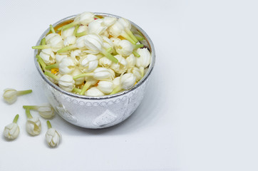 Jasmine, calendula and rose in Thai bowl on white background