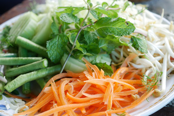 Colorful vegetables served with Thai rice noodles.